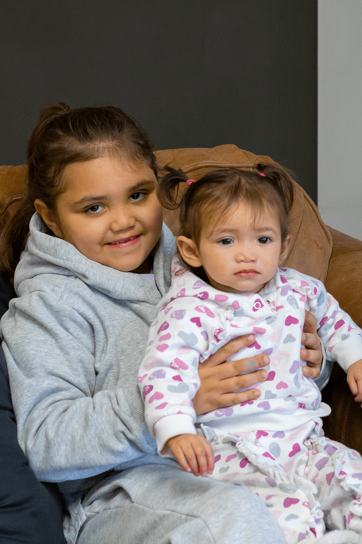 girl holding younger child